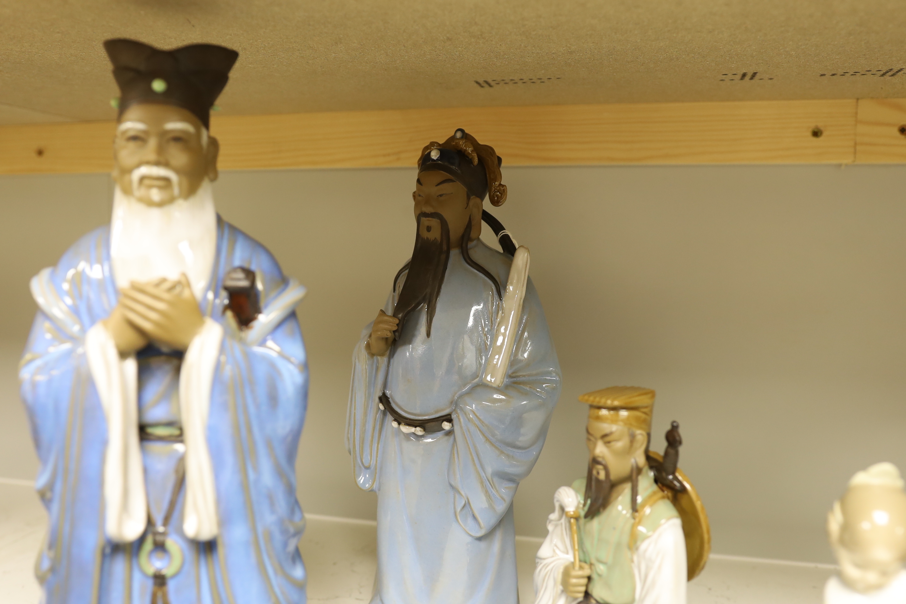 A group of Chinese Shiwan stoneware figures, a composition triptych shrine and a Lladro figure, tallest 33cm high